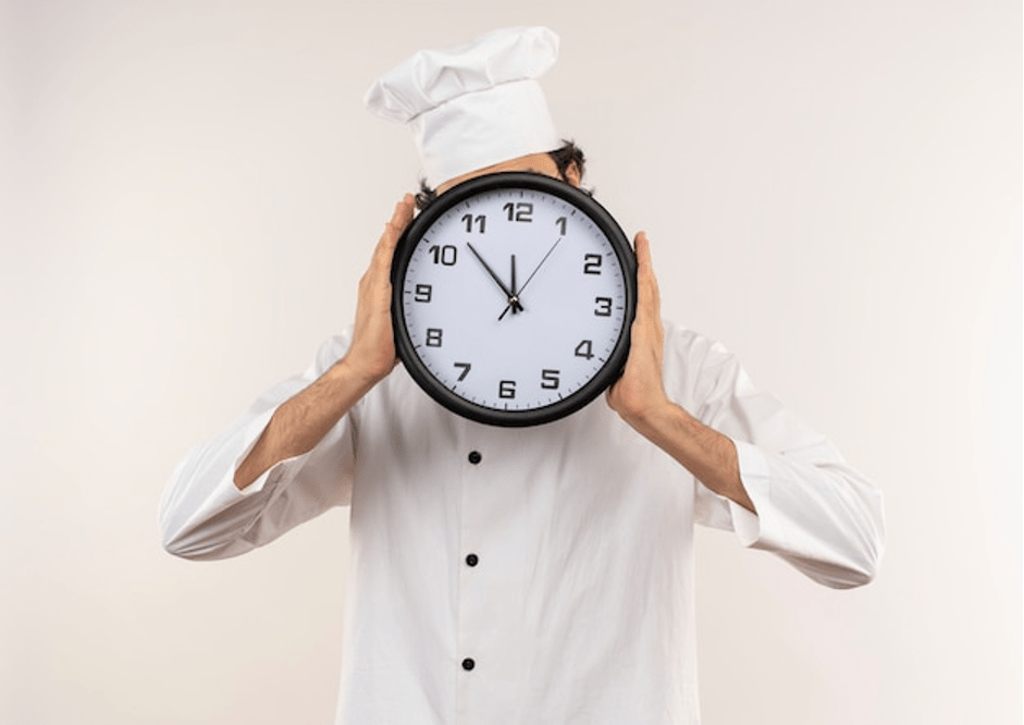 Chef holding clock and showing quick preparation of food