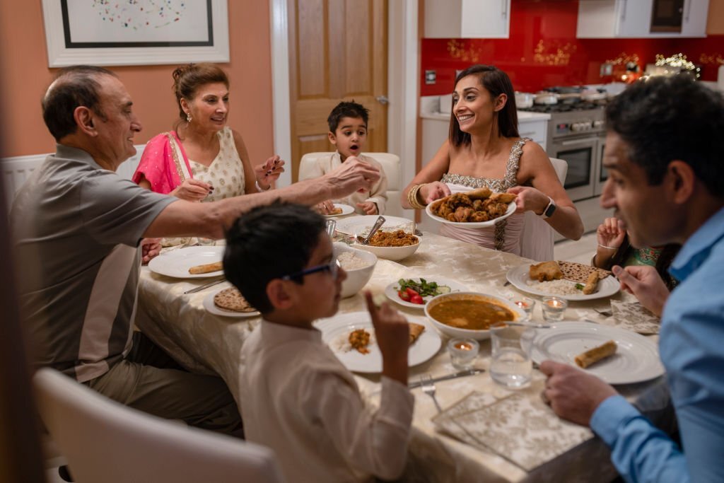 Indian Family Enjoying Festival With Frozen Foods
